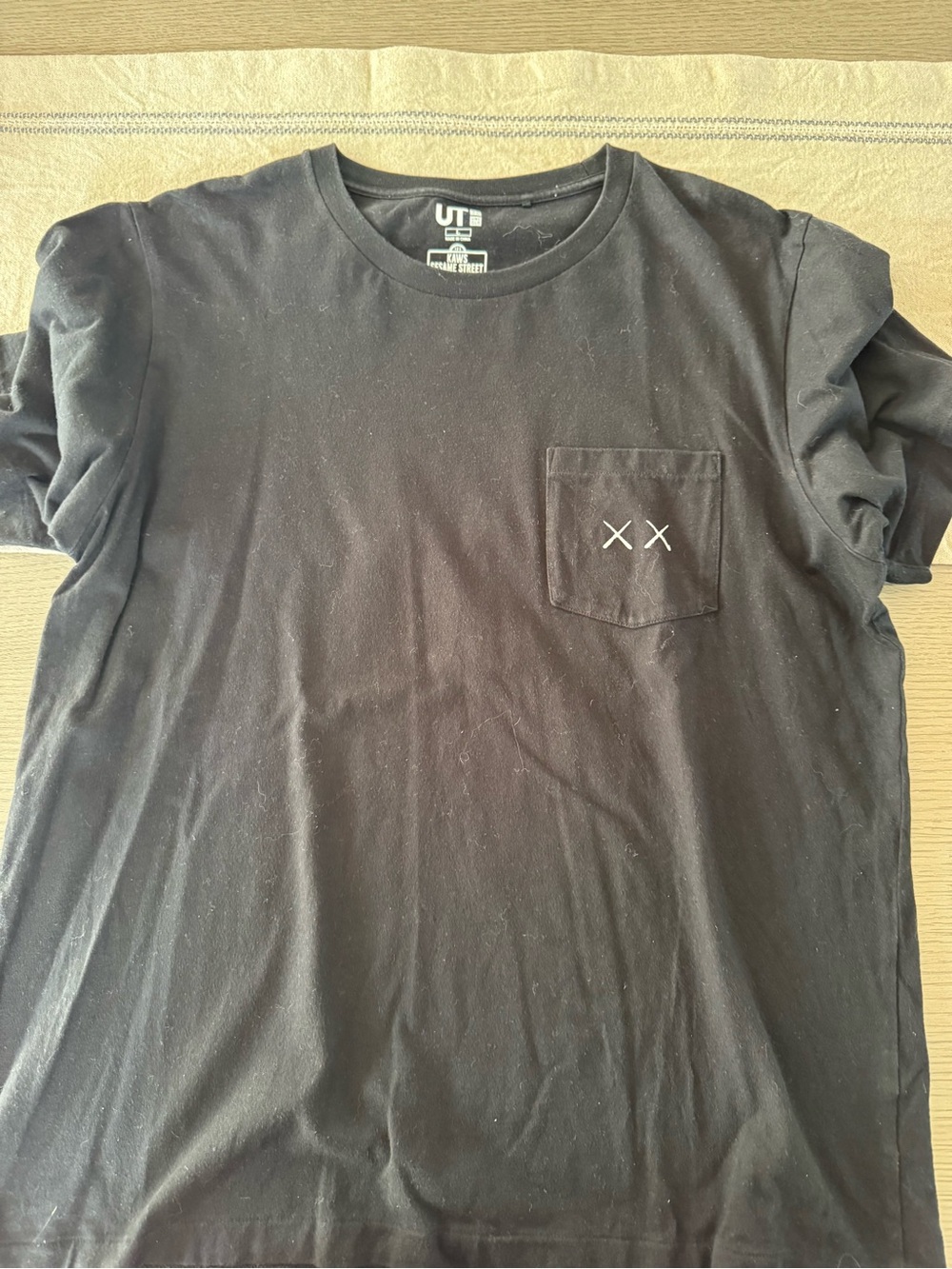 KAWS Black Pocket Tee with White 'XX' Chest Stitching